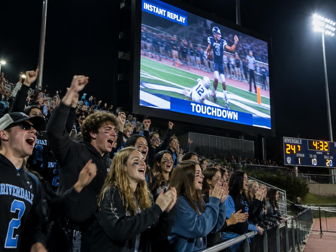 Student section cheering an instant replay